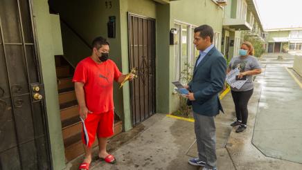 Assembly Member Miguel Santiago canvasses the neighborhood to explain the rent relief application process.