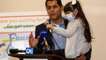 Assembly Member Santiago (and his daughter Brielle) encourage community members to get vaccinated.