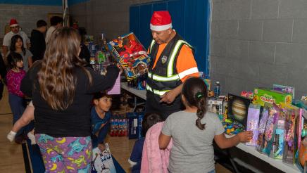 Parents and volunteer helping kids with toys