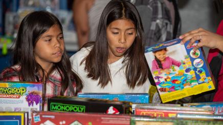 2 young girls looking at toys