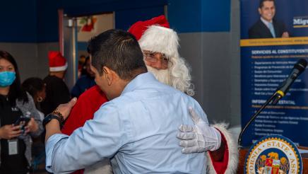 Assemblymember Santiago hugging Santa