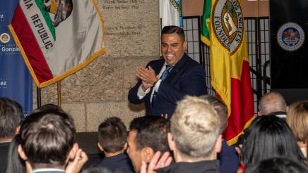 Attendees welcoming Asm. González to the stage