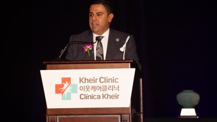 Asm. González at podium, speaking