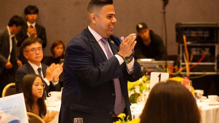 Asm. González standing with hands clasped in thanks