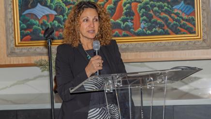 Speaker standing at microphone, speaking